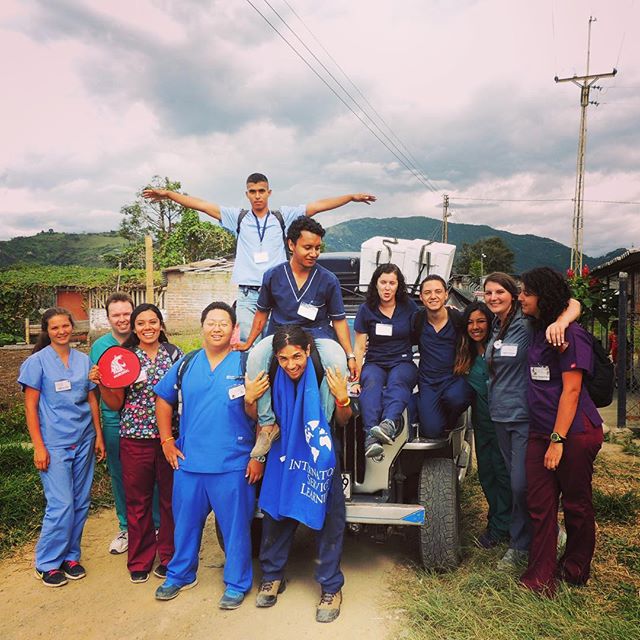 A group of volunteers smiling taking a photo