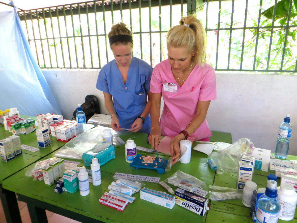 Two nurse volunteers organizing medication