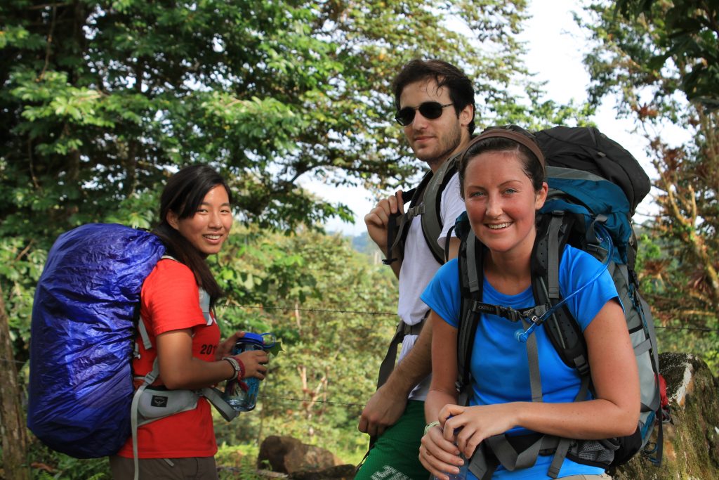Three people smiling after a hike