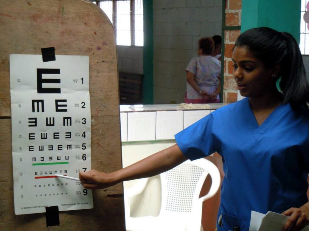A doctor pointing to an eye exam sheet
