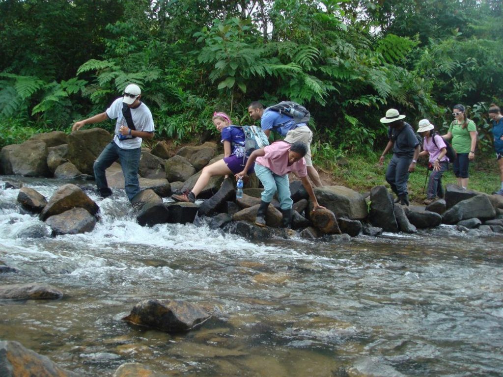 A group of people crossing a river