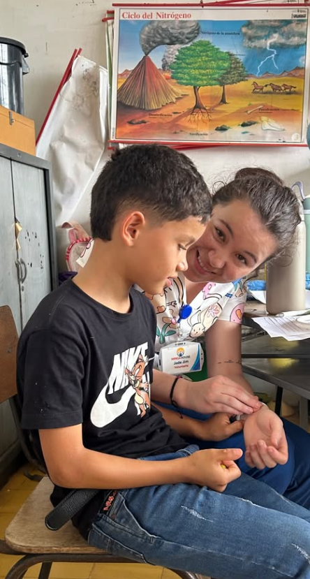 A nurse showing a small child the feeling of her pulse