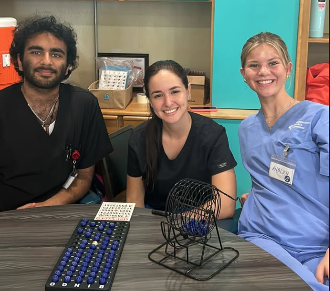 Three volunteer doctors/nurses smiling for a photo