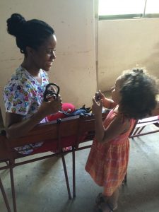 A nurse and a small child smiling and laughing together