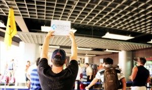A ISL member holding a sign up in an airport