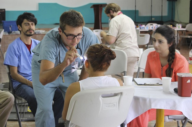 A ISL volunteer doctor helping a child